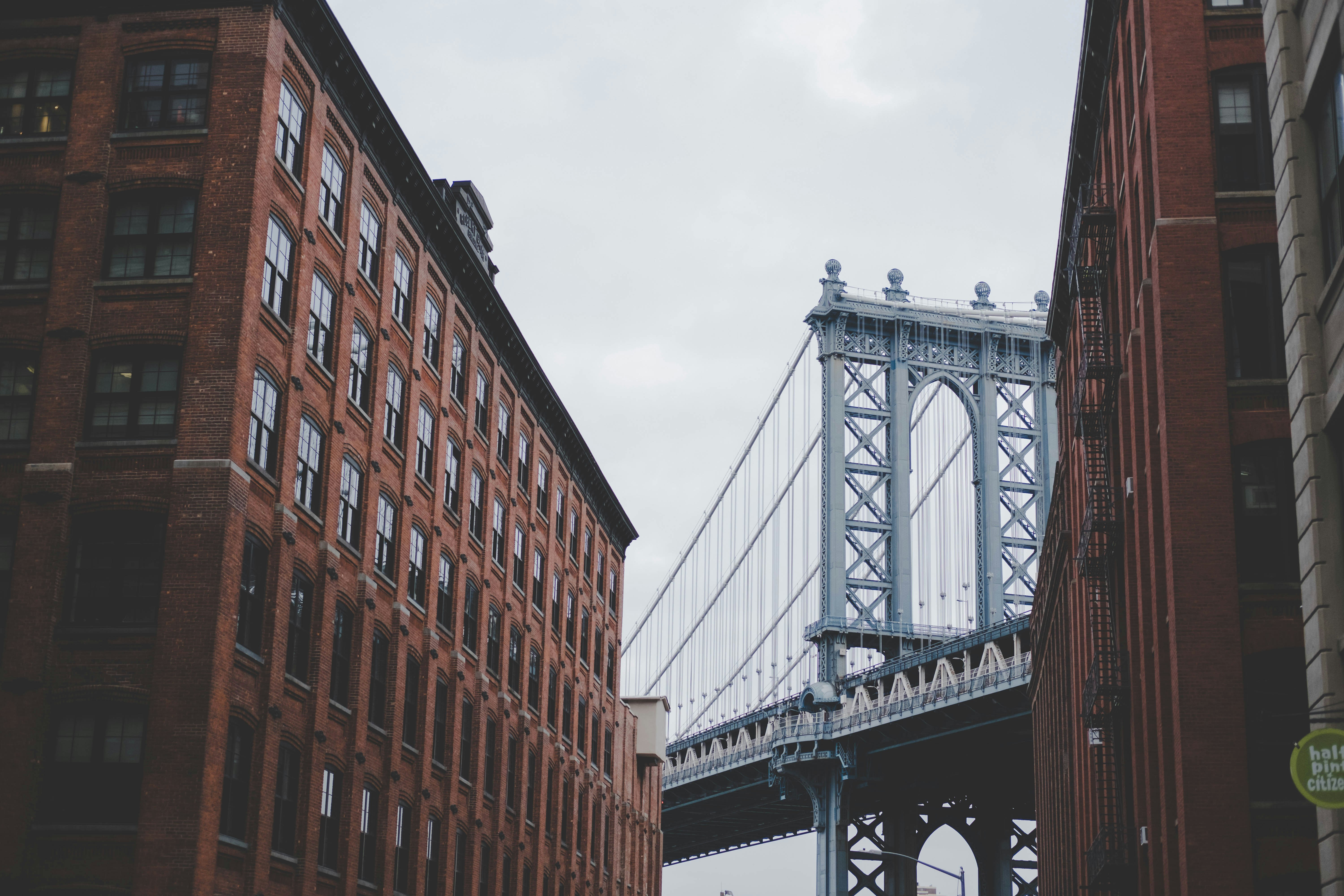 architectural photography of gray bridge and brown building